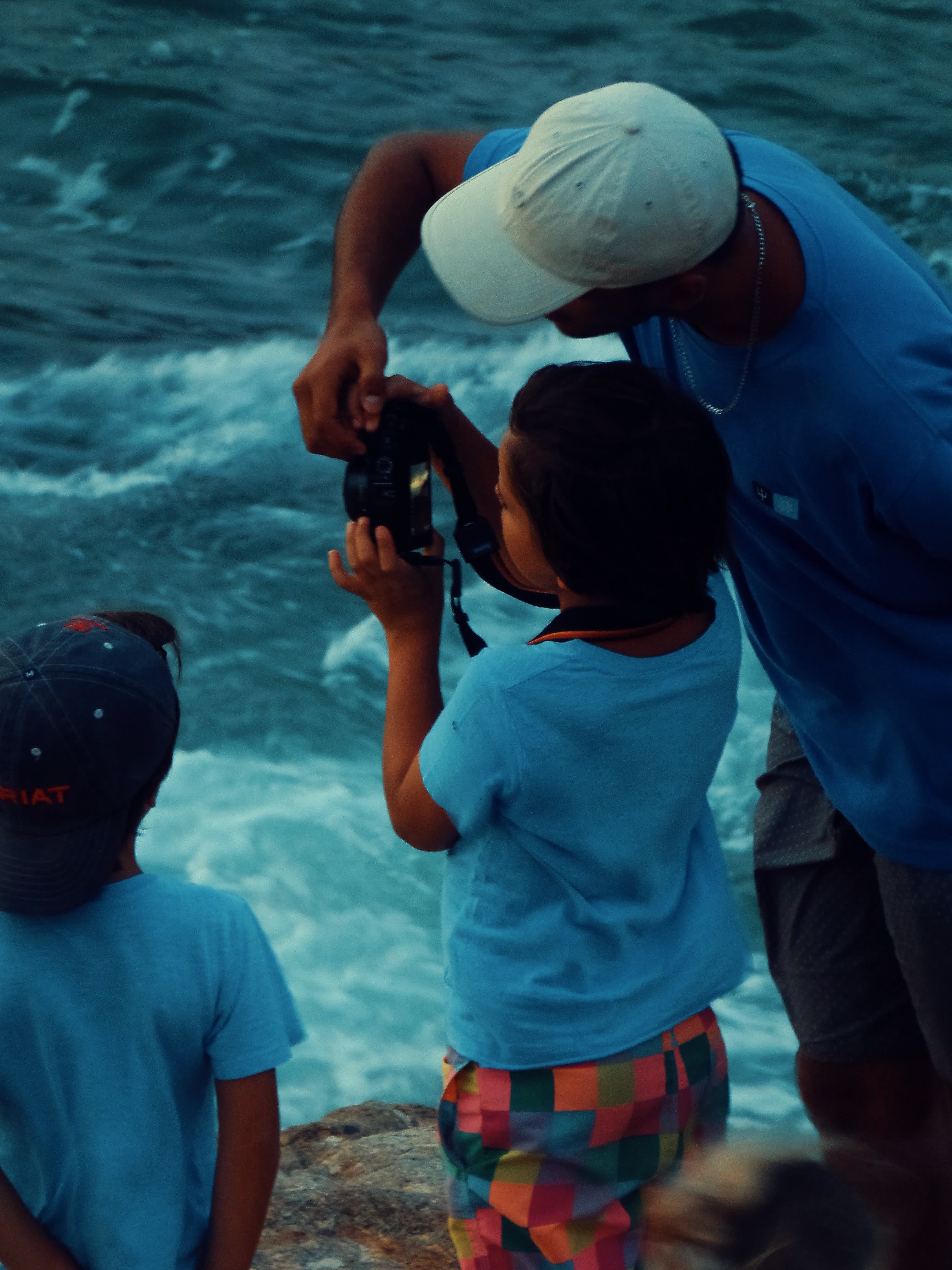 Uma criança aprendendo a fotografar com seu pai